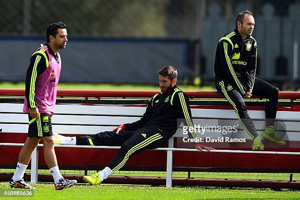 Xavi Hernandez, Sergio Ramos and Andres Iniesta of Spain look on during a Spain training session at Centro de Entrenamiento do Caju on June 21, 2014...