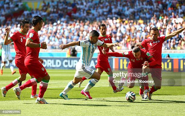 Sergio Aguero of Argentina competes for the ball with Andranik Teymourian of Iran during the 2014 FIFA World Cup Brazil Group F match between...