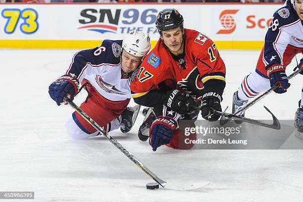 Lance Bouma of the Calgary Flames fights for the puck against Nikita Nikitin of the Columbus Blue Jackets during an NHL game at Scotiabank Saddledome...