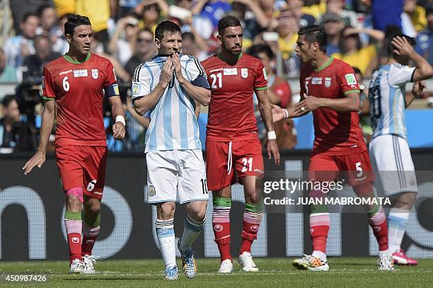 Iran's midfielder and captain Javad Nekounam, Argentina's forward and captain Lionel Messi, Iran's forward Ashkan Dejagah and Iran's defender Amir...