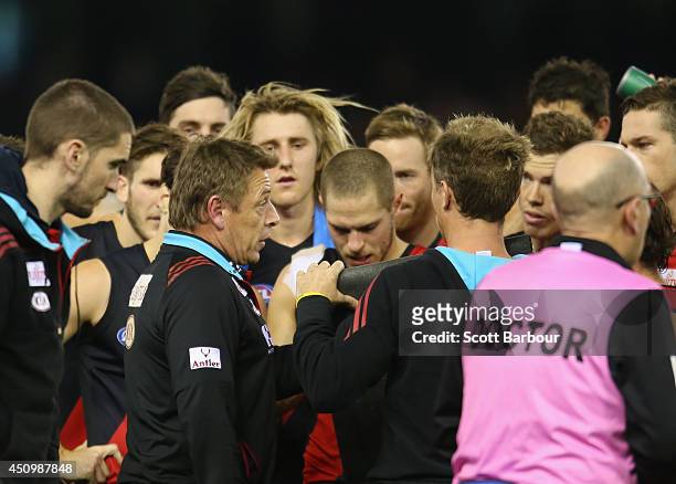 Bombers Head coach Mark Thompson speaks to his team during the round 14 AFL match between the Essendon Bombers and the Adelaide Crows at Etihad...