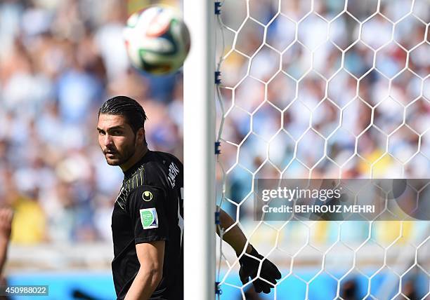 Iran's goalkeeper Alireza Haqiqi eyes the ball during the Group F football match between Argentina and Iran at the Mineirao Stadium in Belo Horizonte...