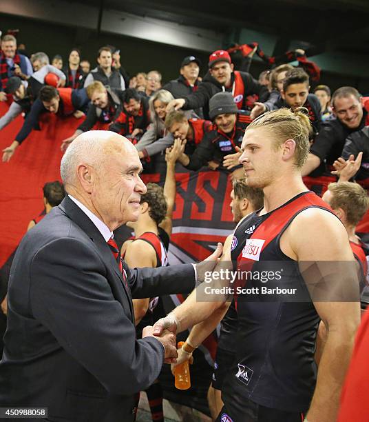 Bombers chairman Paul Little congratulates Michael Hurley as he makes his way to the changing rooms after winning the round 14 AFL match between the...