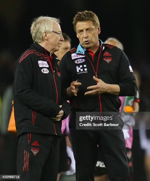 Bombers Head coach Mark Thompson talks with Essendon club doctor Bruce Reid before the round 14 AFL match between the Essendon Bombers and the...