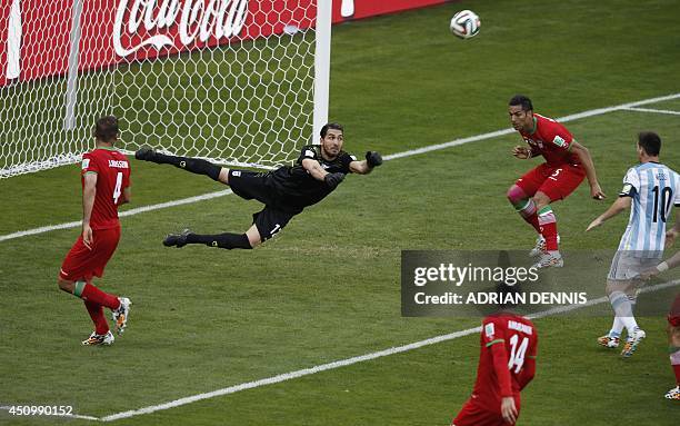 Iran's goalkeeper Alireza Haqiqi makes a save during the Group F football match between Argentina and Iran at the Mineirao Stadium in Belo Horizonte...