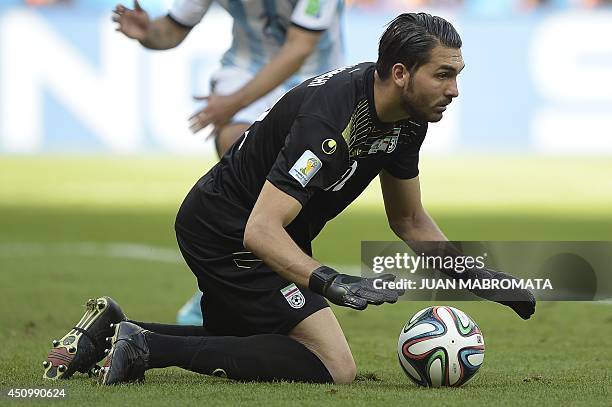 Iran's goalkeeper Alireza Haqiqi saves the ball during a Group F football match between Argentina and Iran at the Mineirao Stadium in Belo Horizonte...