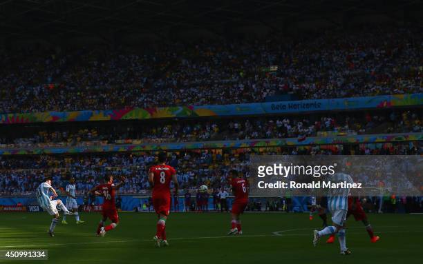 Lionel Messi of Argentina shoots and scores his team's first goal during the 2014 FIFA World Cup Brazil Group F match between Argentina and Iran at...