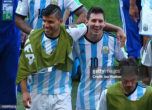 Sergio Aguero and Lionel Messi of Argentina react while walking off the field after defeating Iran 1-0 during the 2014 FIFA World Cup Brazil Group F...