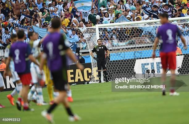 Iran's goalkeeper Alireza Haqiqi reacts during the Group F football match between Argentina and Iran at the Mineirao Stadium in Belo Horizonte during...