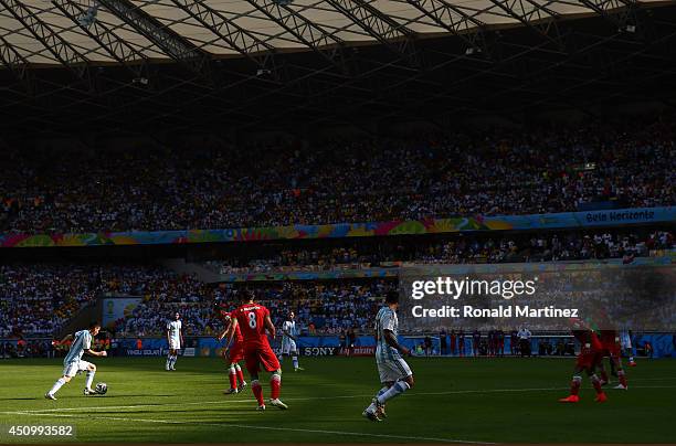 Lionel Messi of Argentina shoots and scores his team's first goal during the 2014 FIFA World Cup Brazil Group F match between Argentina and Iran at...