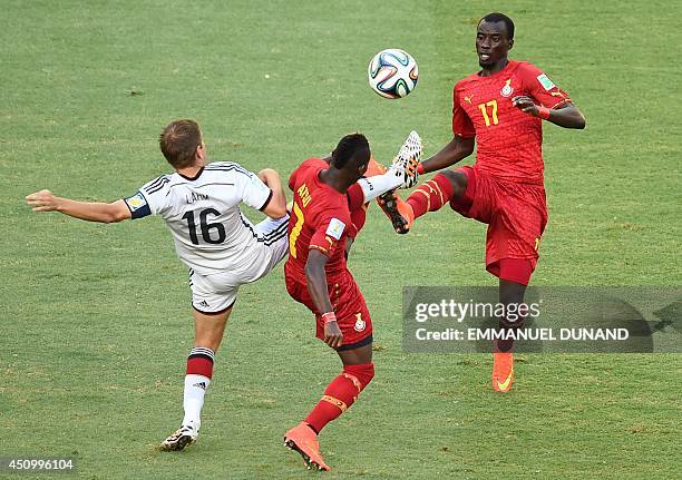 Germany's defender and captain Philipp Lahm vies with Ghana's midfielder Christian Atsu Twasam and Ghana's midfielder Mohammed Rabiu during a Group G...