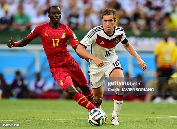 Germany's defender and captain Philipp Lahm vies with Ghana's midfielder Mohammed Rabiu during a Group G football match between Germany and Ghana at...