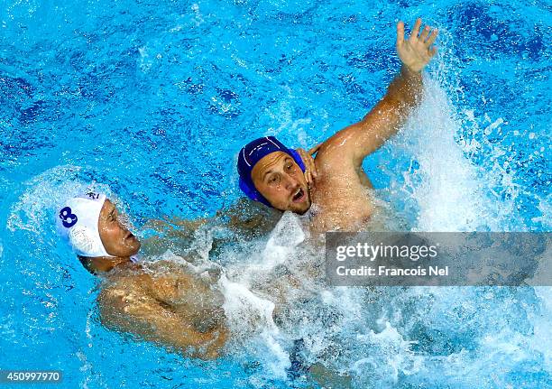 Andrija Prlainovic of Serbia competes for the ball with Marton Szivos of Hungary during the Fina Men's Water Polo World League Super Final match...