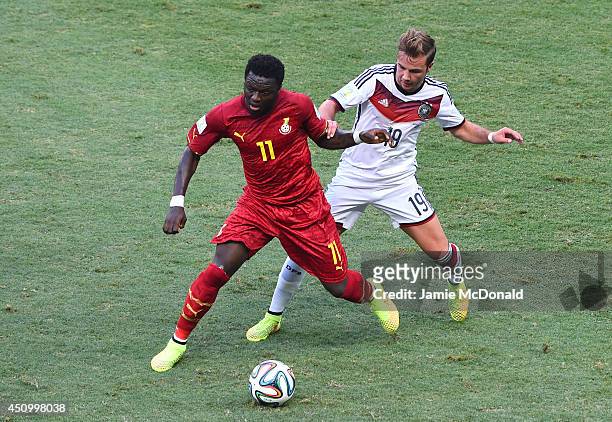 Sulley Muntari of Ghana and Mario Goetze of Germany compete for the ball during the 2014 FIFA World Cup Brazil Group G match between Germany and...