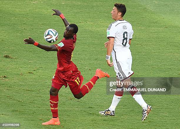 Ghana's midfielder Mohammed Rabiu vies with Germany's midfielder Mesut Ozil during a Group G football match between Germany and Ghana at the Castelao...