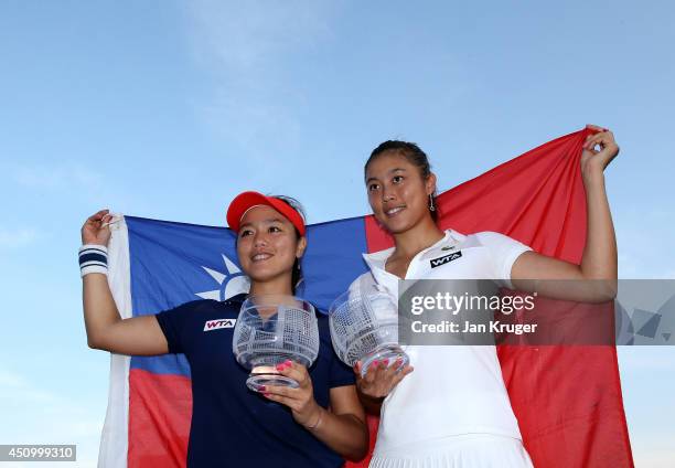 Hao-Ching and Yung-Jan Chan of Chinese Taipei pose with the trophy after beating Martina Hingis of Switzerland and Flavia Pennetta of Italy during...