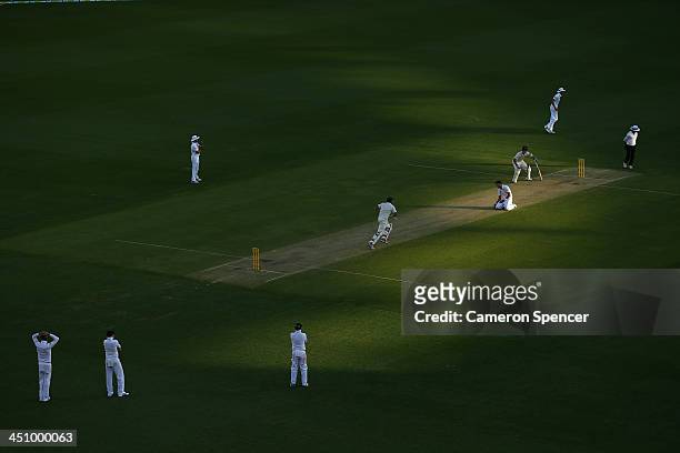 James Anderson of England bowls to Ryan Harris of Australia during day one of the First Ashes Test match between Australia and England at The Gabba...