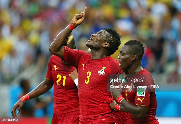 Asamoah Gyan of Ghana celebrates scoring his team's second goal with his teammates Christian Atsu and John Boye of Ghana during the 2014 FIFA World...