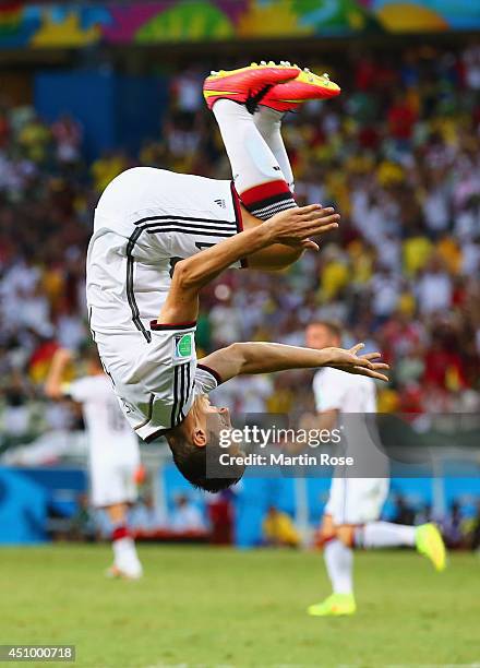 Miroslav Klose of Germany does a flip in celebration of scoring his team's second goal during the 2014 FIFA World Cup Brazil Group G match between...