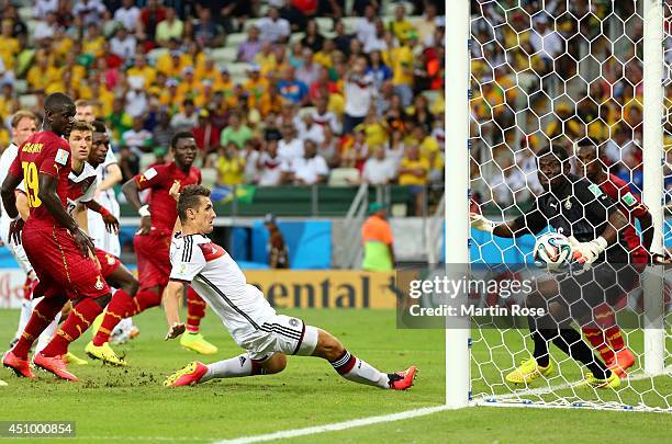 Miroslav Klose of Germany scores his team's second goal past Fatawu Dauda of Ghana during the 2014 FIFA World Cup Brazil Group G match between...