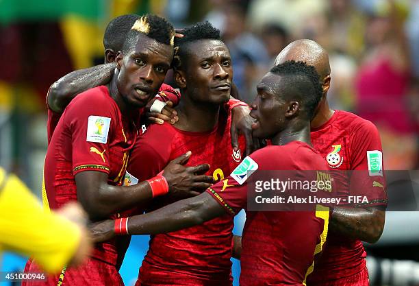 Asamoah Gyan of Ghana celebrates scoring his team's second goal with his teammates Christian Atsu and John Boye during the 2014 FIFA World Cup Brazil...