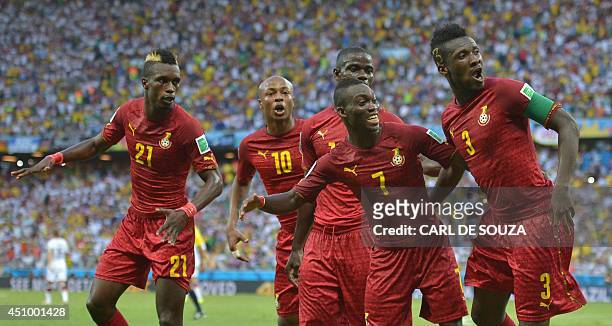Ghana's forward and captain Asamoah Gyan dances with teammates to celebrate after scoring during a Group G football match between Germany and Ghana...