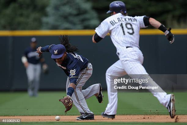 Second baseman Rickie Weeks of the Milwaukee Brewers commits an error on a ground ball by Drew Stubbs of the Colorado Rockies allowing Charlie...