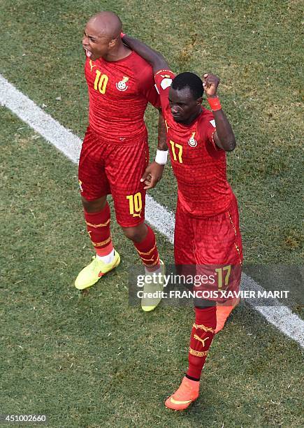 Ghana's forward and captain Asamoah Gyan celebrates with Ghana's midfielder Mohammed Rabiu after scoring during a Group G football match between...