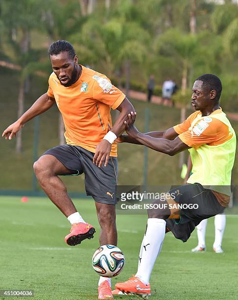 Ivory Coast's forward Didier Drogba and Ivory Coast's defender Ousmane Viera take part in a training session in Aguas de Lindoia, on June 21 during...