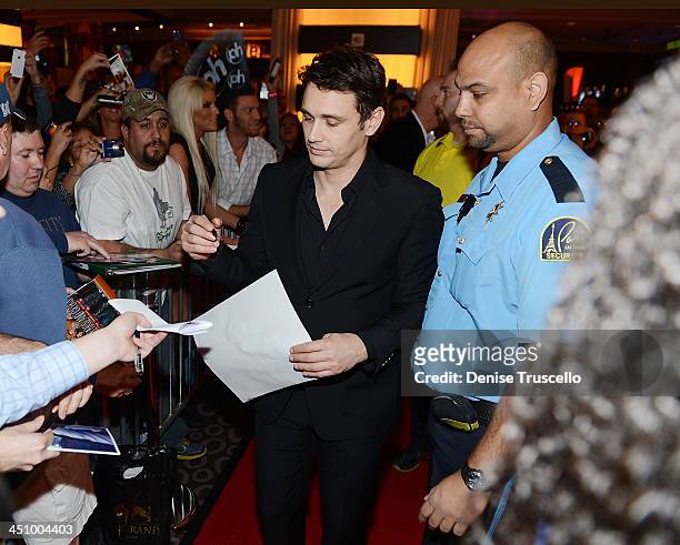 James Franco signs autographs for fans at the "Homefront" premiere at Planet Hollywood Resort & Casino on November 20, 2013 in Las Vegas, Nevada.