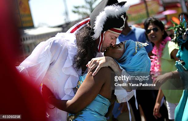 New York City Mayor Bill de Blasio kisses his wife Chirlane McCray on the boardwalk in the 2014 Mermaid Parade at Coney Island on June 21, 2014 in...