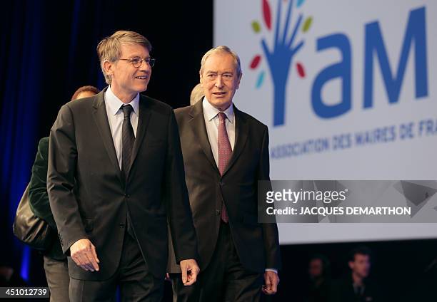 French Education Minister Vincent Peillon and President of the Mayors of France association Jacques Pelissard arrive to take part in a debate during...