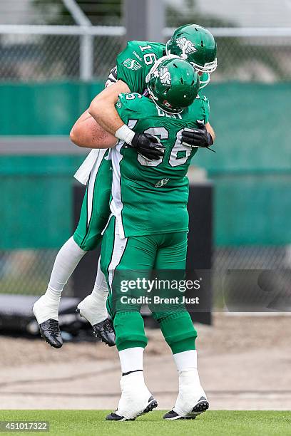 Brett Swain and Chris Best of the Saskatchewan Roughriders celebrate a touchdown during pre-season week B of the 2014 CFL season in a game between...