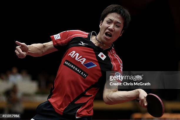 Jun Mizutani of Japan returns a shot against Yuto Muramatsu of Japan during their Men's Singles Semi final match on day three of 2014 ITTF World Tour...