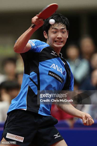 Yuto Muramatsu of Japan returns a shot against Jun Mizutani of Japan during their Men's Singles Semi final match on day three of 2014 ITTF World Tour...