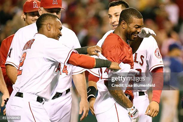 Erick Aybar congratulates teammate Howie Kendrick of the Los Angeles Angels of Anaheim after driving in the winning run to defeat the Texas Rangers...