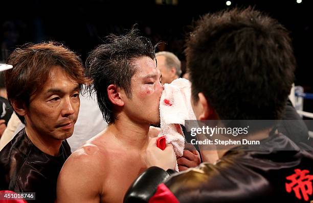 Yoshihiro Kamegai is worked on by his trainers after fighting Robert Guerrero in their welterweight bout at StubHub Center on June 21, 2014 in Los...