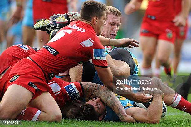 Mark Minichiello of the Titans scores a try during the round 15 NRL match between the Gold Coast Titans and the St George Illawarra Dragons at Cbus...