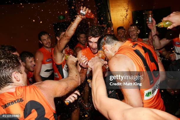 Kristian Jaksch and Tom Boyd of the Giants celebrates with team mates and sing the club song after victory in the round 14 AFL match between the...