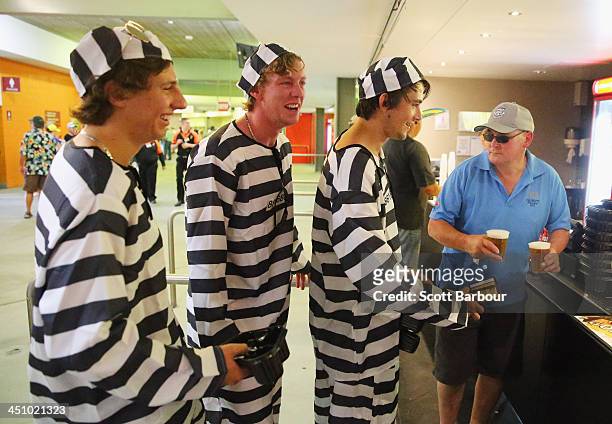 Barmy Army members dressed as convicts wait in line to purchase beer during day one of the First Ashes Test match between Australia and England at...