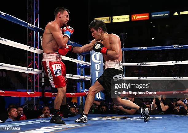 Yoshihiro Kamegai throws a punch at Robert Guerrero in their welterweight bout at StubHub Center on June 21, 2014 in Los Angeles, California....