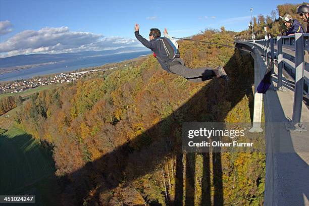 bridge base jumper is exiting with braking line - bungee stock pictures, royalty-free photos & images