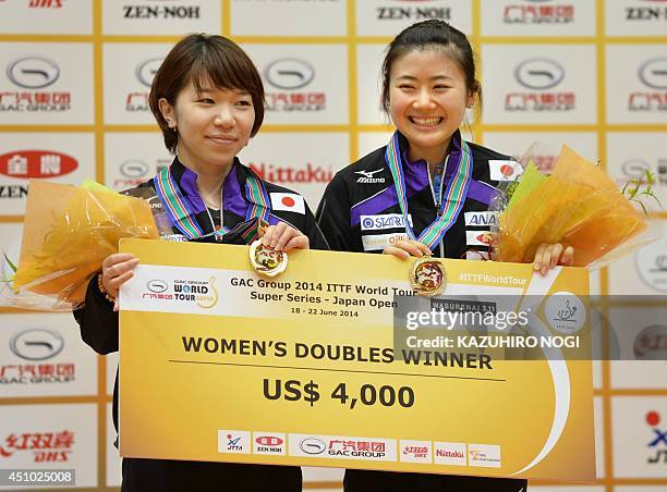 Japan's doubles pair Ai Fukuhara and Misako Wakamiya celebrate their victory during a medal ceremony after their women's doubles final against...