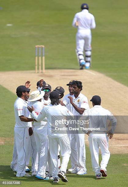 Shaminda Eranga of Sri Lanka, centre, celebrates taking the wicket of Chris Jordan of England, top, during day three of the 2nd Investec Test match...