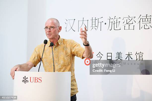 Swiss artist photographer Hannes Schmid speaks during the opening of Hannes Schmid's MOMENTOUS presented by UBS at Today Art Museum on June 22, 2014...