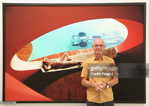 Swiss artist photographer Hannes Schmid poses for photos in front of his works during the opening of Hannes Schmid's MOMENTOUS presented by UBS at...