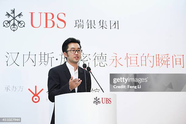 Alex Gao, Executive Director of Today Art Museum speaks during the opening of Swiss artist photographer Hannes Schmid's MOMENTOUS presented by UBS at...