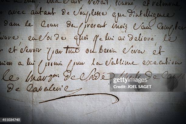 Picture taken on May 21, 2014 in Boulogne-Billancourt, outside Paris, shows a very rare signature of French writer the Marquis de Sade, with his...