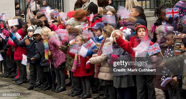 School Children await Queen Elizabeth II and Prince Philip, Duke of Edinburgh on a visit to Southwark Cathedral on November 21, 2013 in London,...