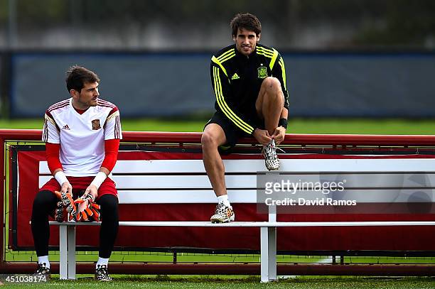 Iker Casillas and Javi Martinez of Spain look on during a training session ahead of their 2014 FIFA World Cup Group B match between Australia and...